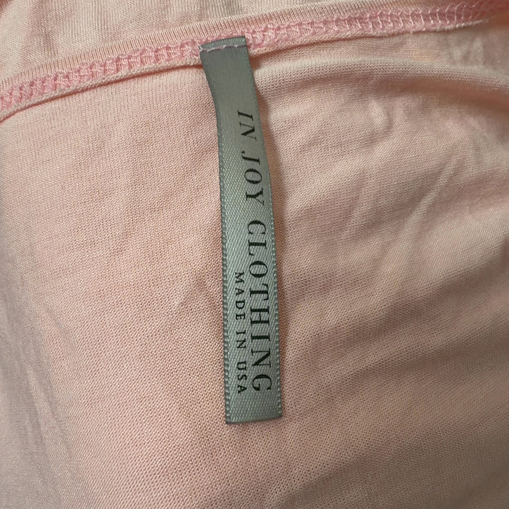 Pink twisted front top with ruched detailing, back view showing knot detail