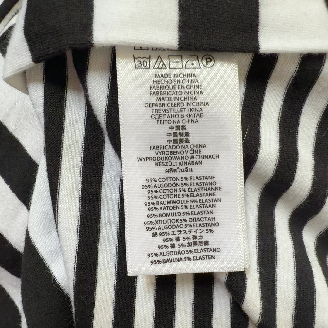 Black and white striped Michael Kors top back view showing fitted silhouette and gold side zip detail