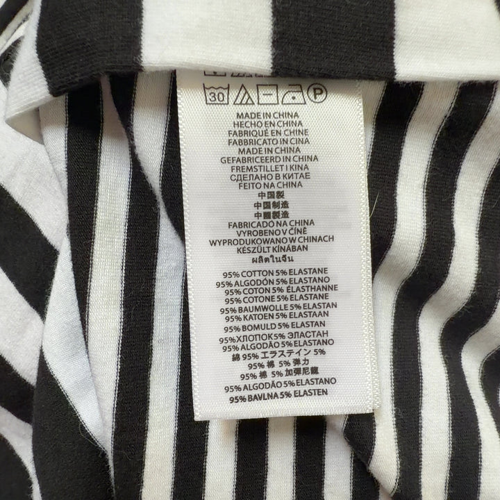 Black and white striped Michael Kors top back view showing fitted silhouette and gold side zip detail