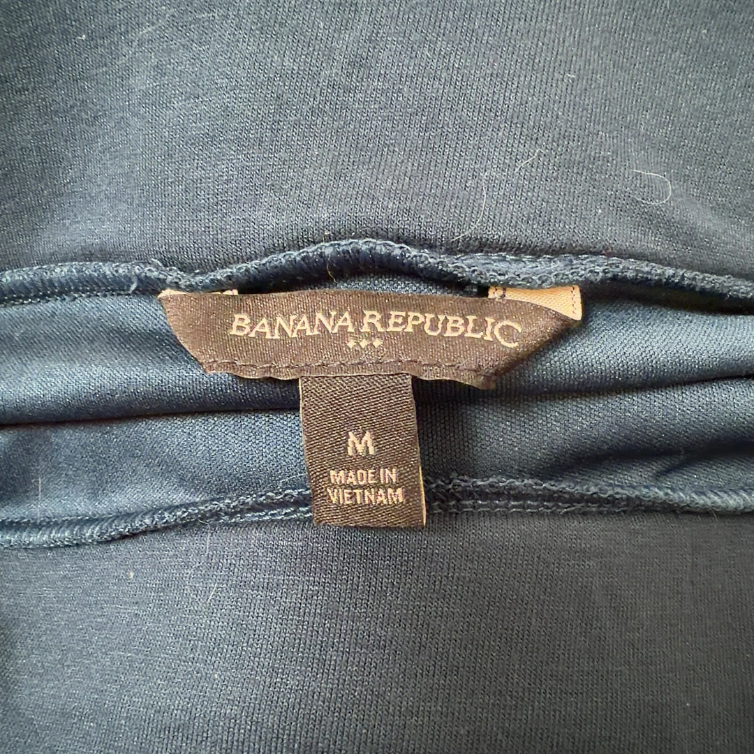 Navy strapless ruched top with ruched back detail, back view on model