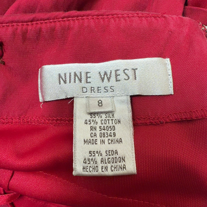 Red ruched midi cocktail dress with spaghetti straps, back view