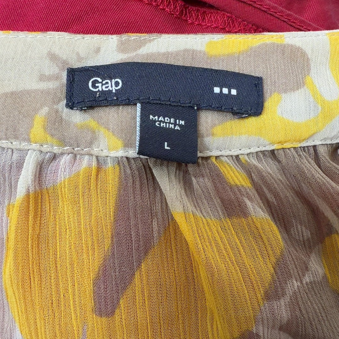Tag view of Gap yellow floral sleeveless top showing elasticized waist and relaxed fit