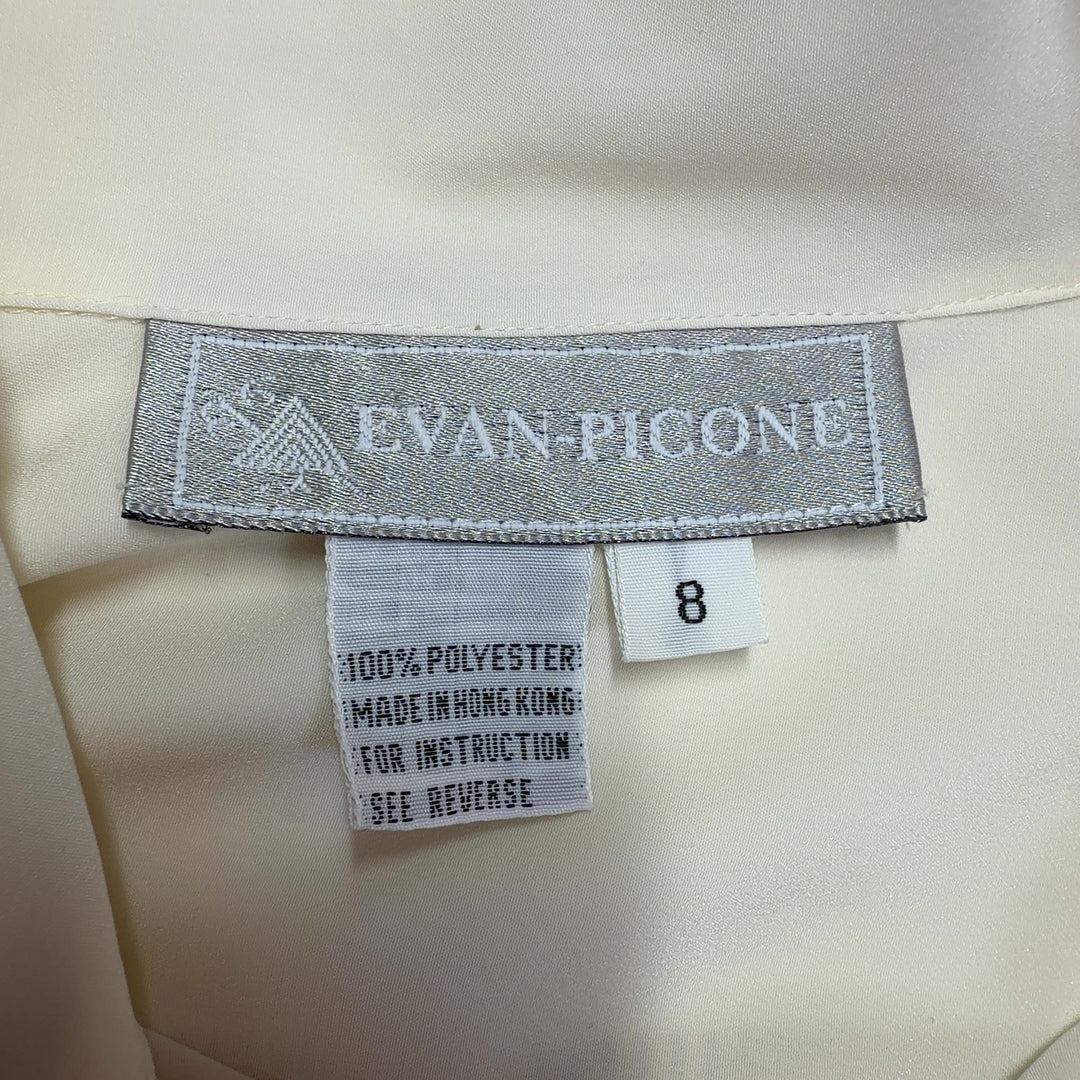 Cream button-up blouse back view showing full-length sleeves and button closure