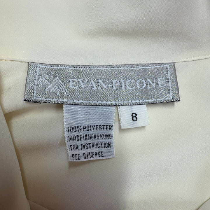 Cream button-up blouse back view showing full-length sleeves and button closure