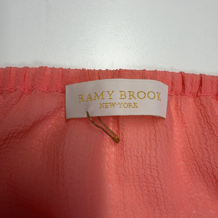 Coral tiered sleeveless dress with beaded trim and gold tassel details, back view
