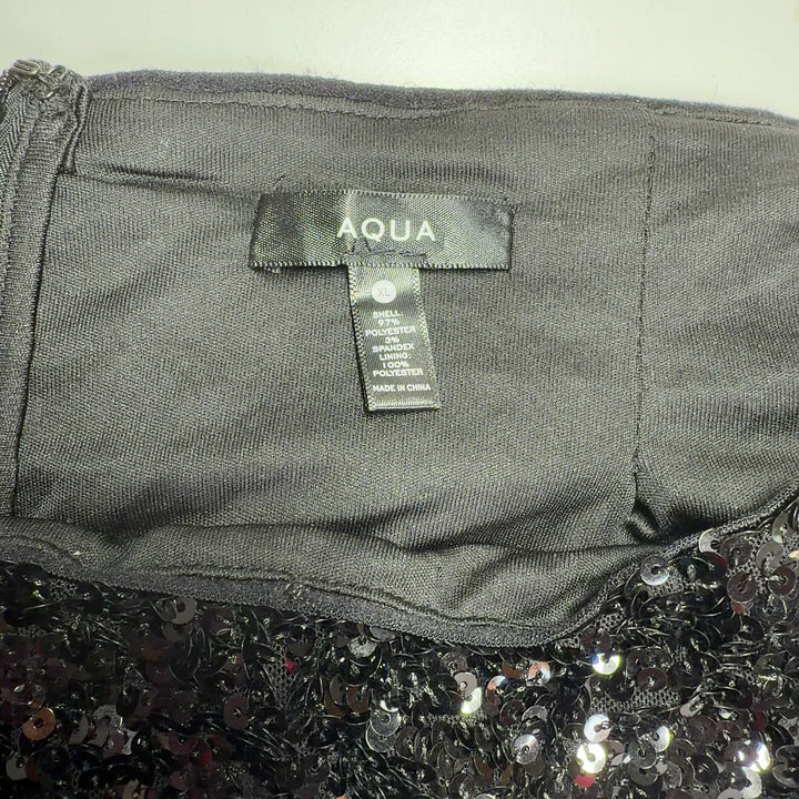 Black sequin midi skirt back view, showing full sequin coverage and elegant silhouette