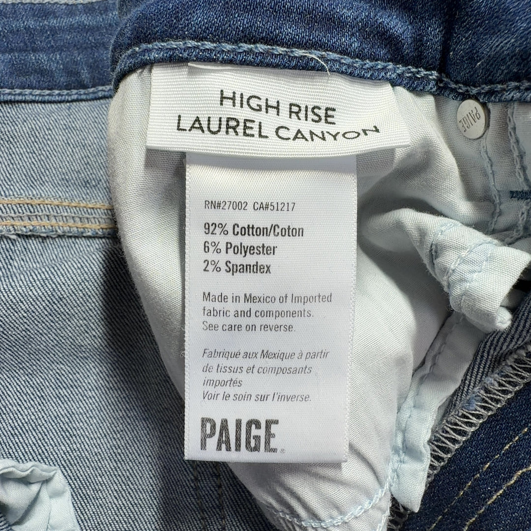 Tag view of Paige blue flare jeans highlighting the high-waisted silhouette and flattering fit on size L