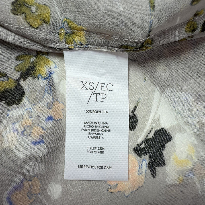 Tag view of cream floral print Cabi button-up shirt showing relaxed fit and full botanical print design