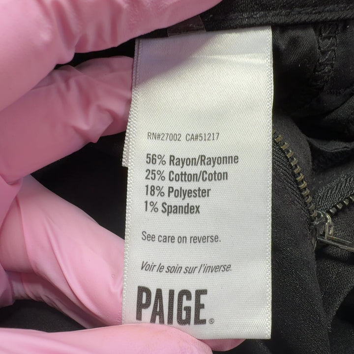 Black cargo denim pants by Paige showing back pockets and cargo details, side view