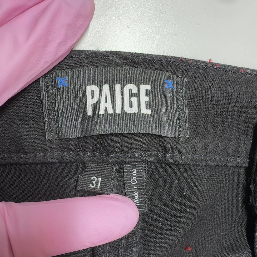 Black cargo denim pants by Paige showing back pockets and cargo details, side view
