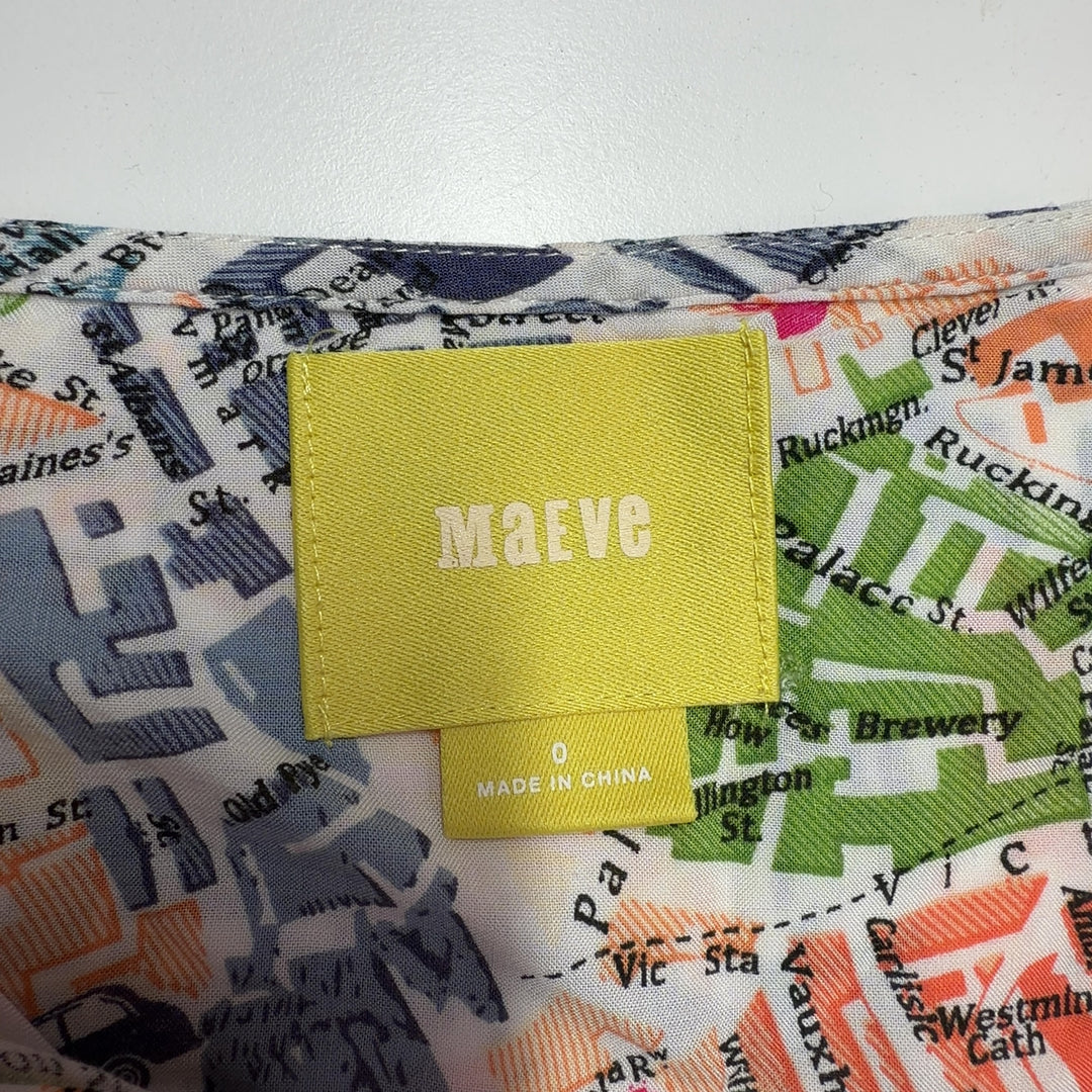 Tag view of multicolor newspaper print rayon blouse by Mango showing peplum hem detail and relaxed fit
