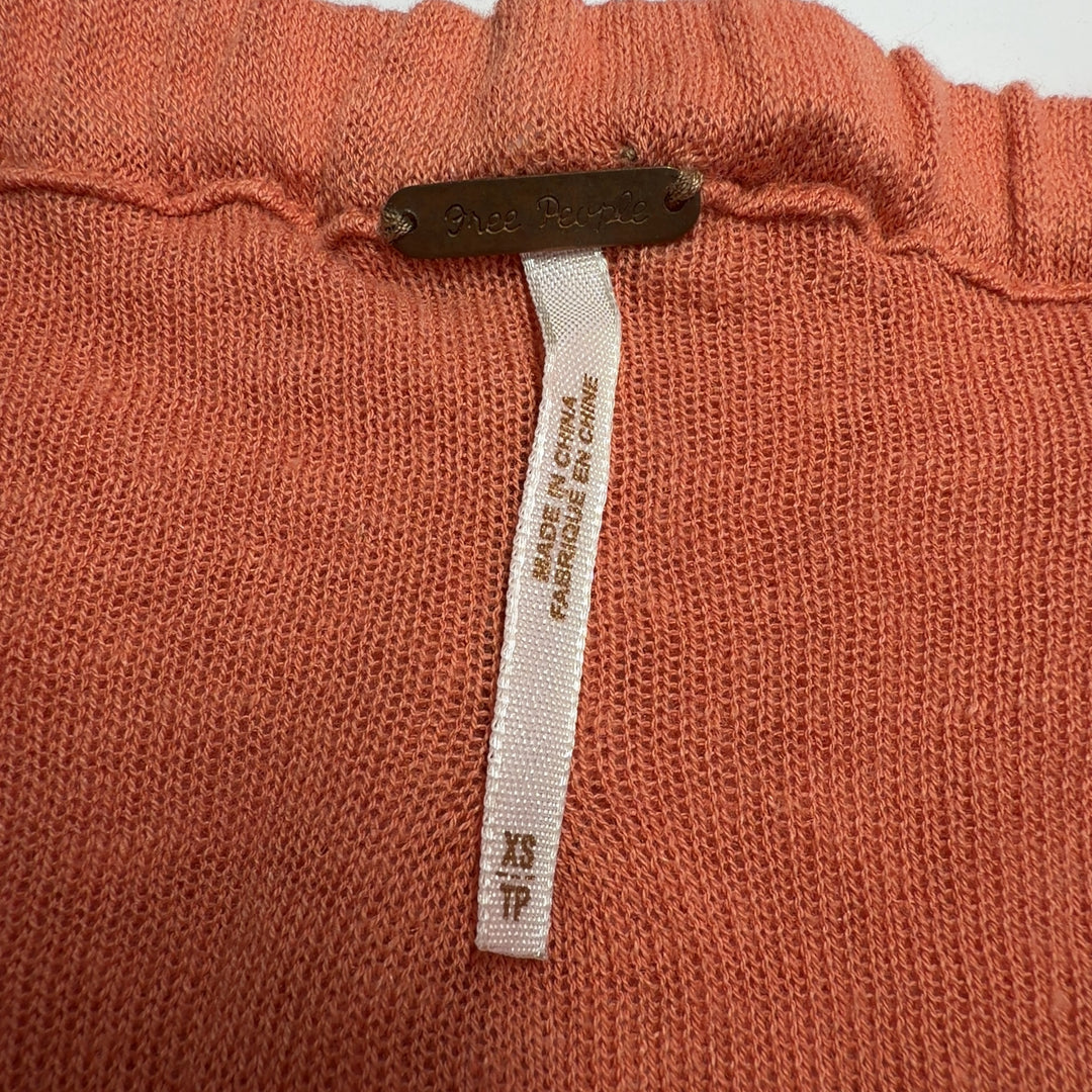 Free People orange ruched cotton-linen top with gathered fabric detail, back view on model