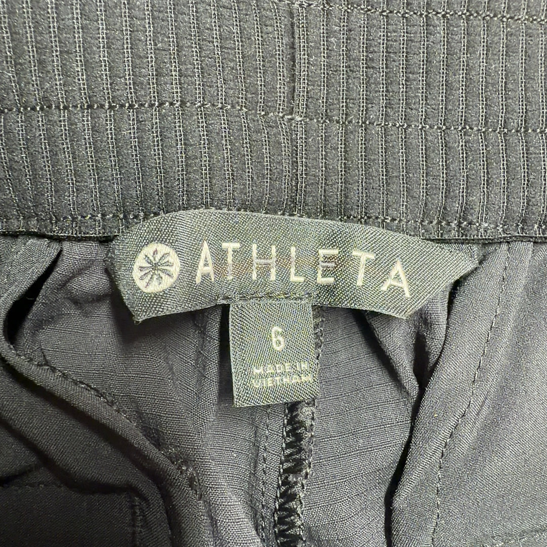 Black Athleta athletic shorts shown from back view, displaying flattering silhouette and side vent details