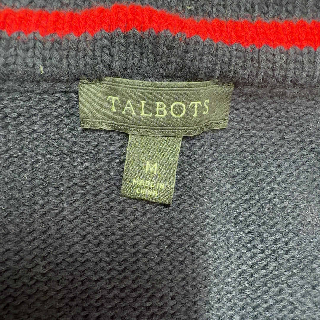 Black cotton cardigan with striped trim, back view showing zip closure and overall silhouette