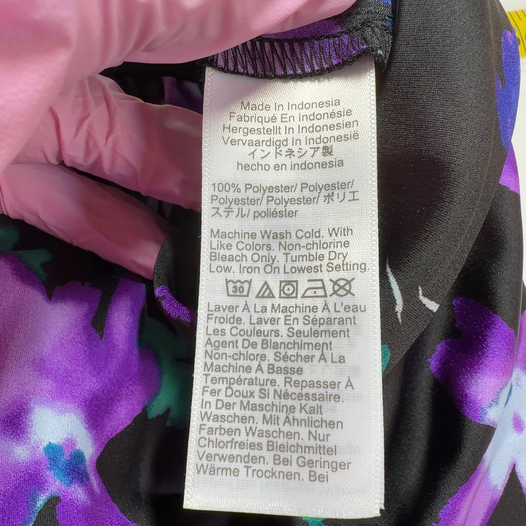 Black floral midi pencil skirt back view showing straight silhouette and vibrant botanical pattern