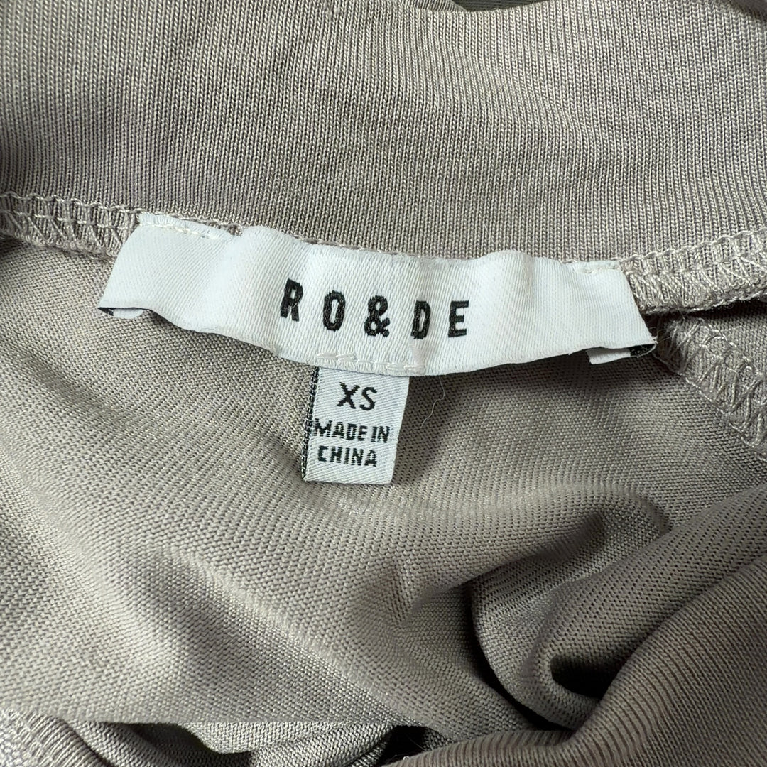 Beige cold shoulder long sleeve top back view, showing relaxed fit and elegant drape