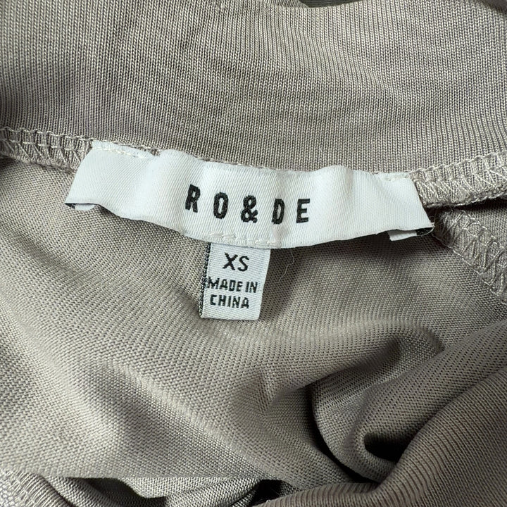 Beige cold shoulder long sleeve top back view, showing relaxed fit and elegant drape