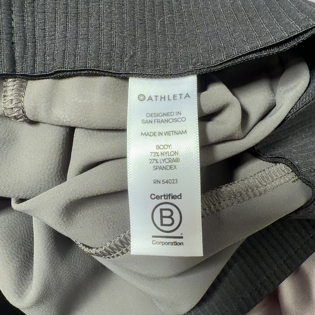 Olive green Athleta activewear pants back view, showing flattering fit and drape