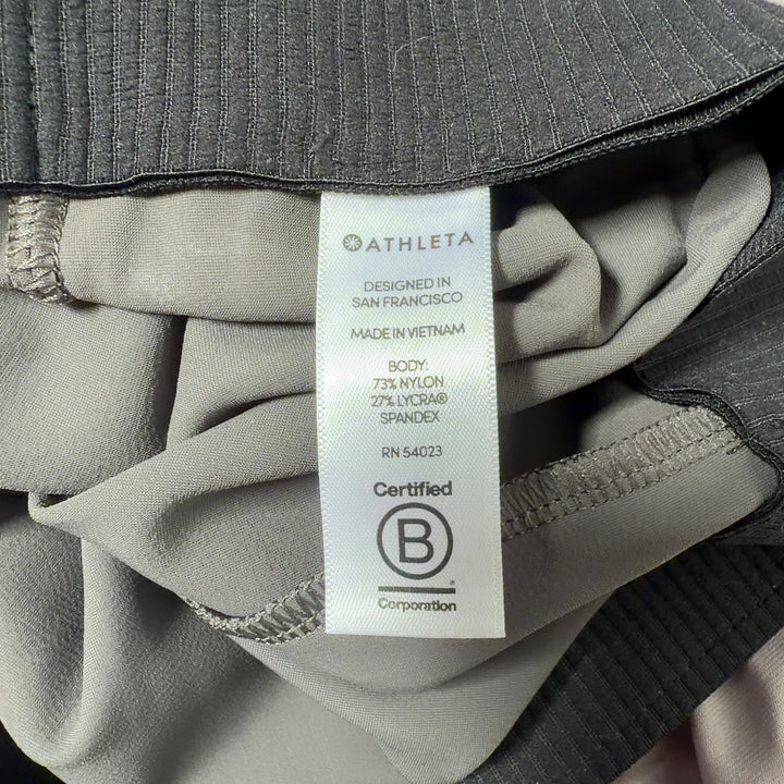 Olive green Athleta activewear pants back view, showing flattering fit and drape
