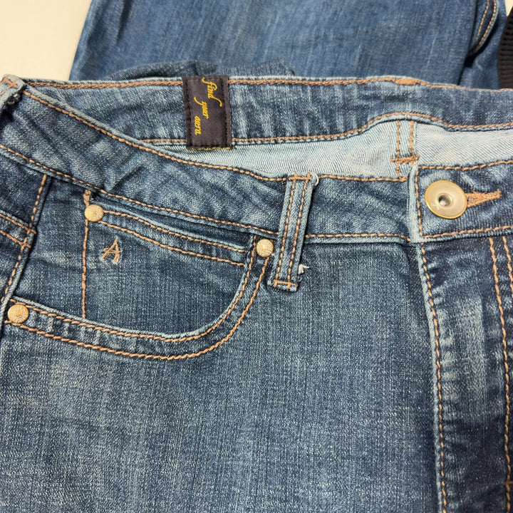 Tag view of blue denim flare jeans by Aura at Wrangler, size XL, showing flared leg design and classic denim construction