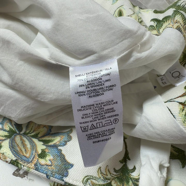 Tag view of cream floral print LOFT shorts showing A-line silhouette and botanical floral pattern