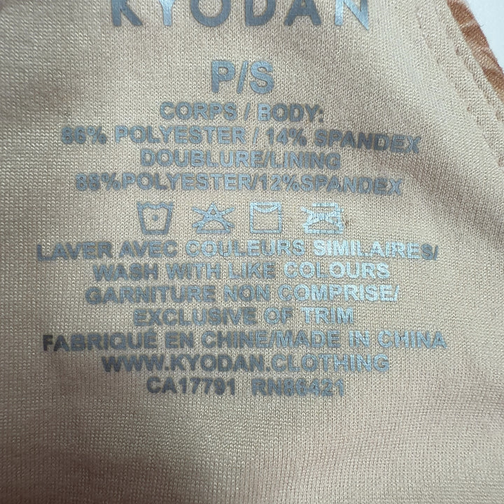 Beige textured crop tank top, back view showing sleeveless design and fitted silhouette