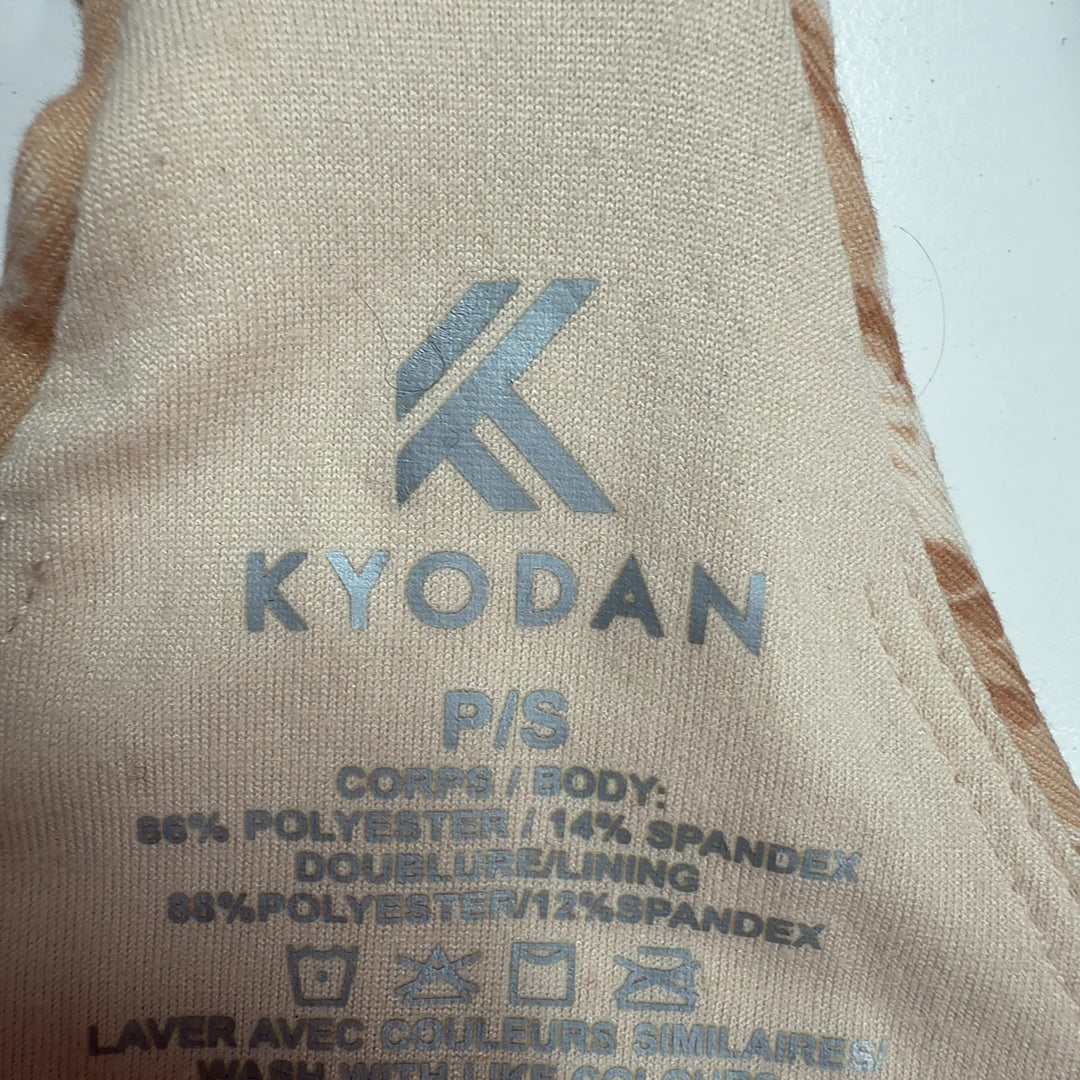 Beige textured crop tank top, back view showing sleeveless design and fitted silhouette