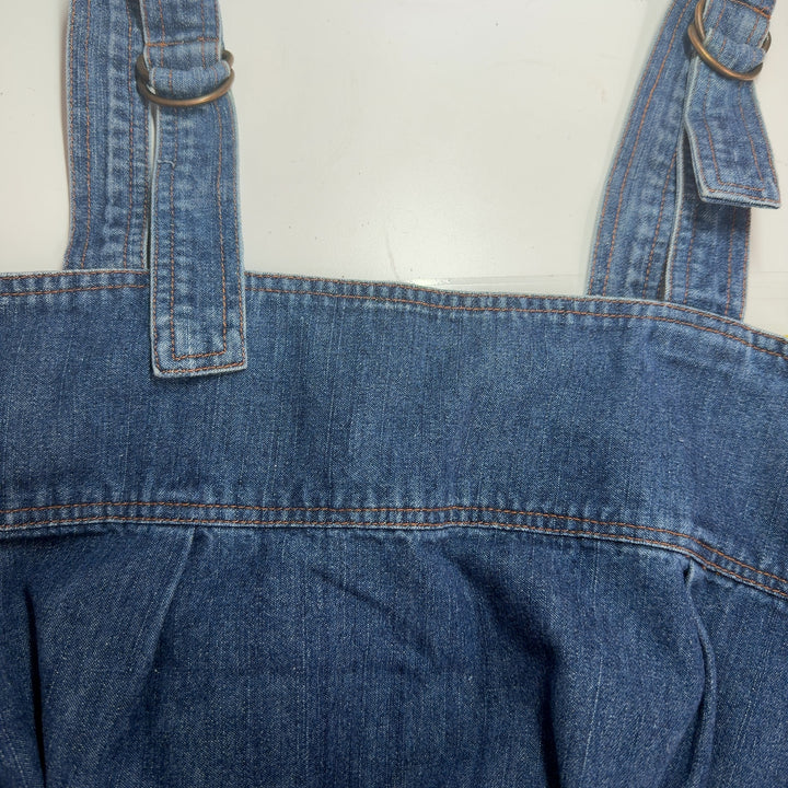 Blue denim sleeveless shift dress with adjustable straps and back patch pocket, back view
