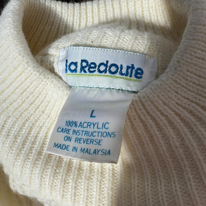 Tag view of cream ribbed knit sweater dress showing oversized fit and knee-length hem