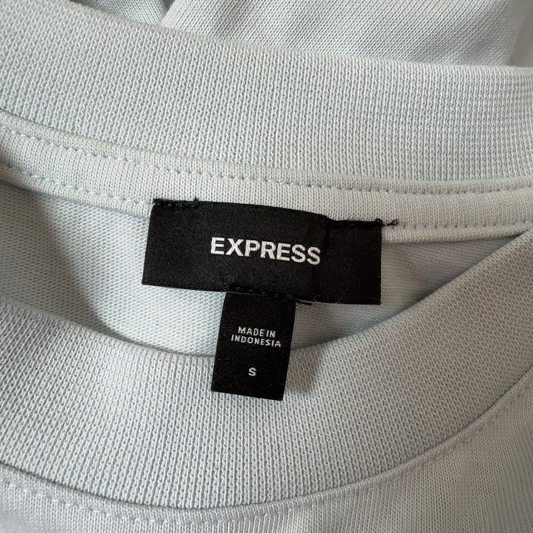 Cream oversized cotton-blend t-shirt back view showing relaxed fit and length