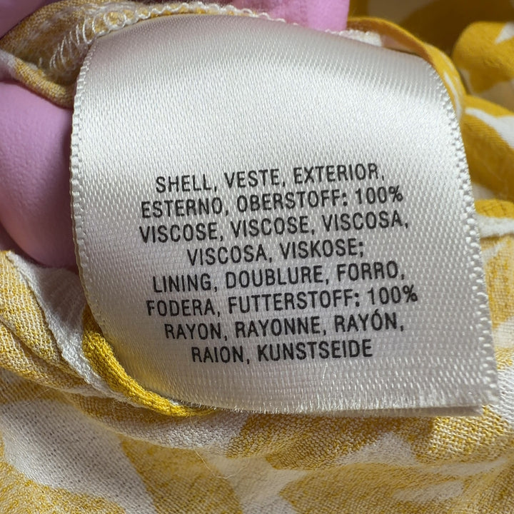 Tag view of yellow abstract print Maeve all-in-one jumpsuit showing flowing wide-leg design