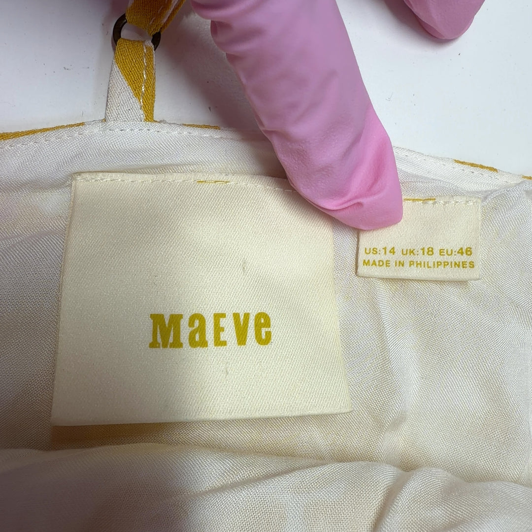 Tag view of yellow abstract print Maeve all-in-one jumpsuit showing flowing wide-leg design