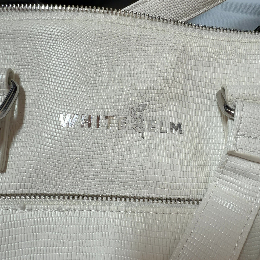 WHITE ELM cream leather tote bag worn on shoulder, back view showing structured silhouette
