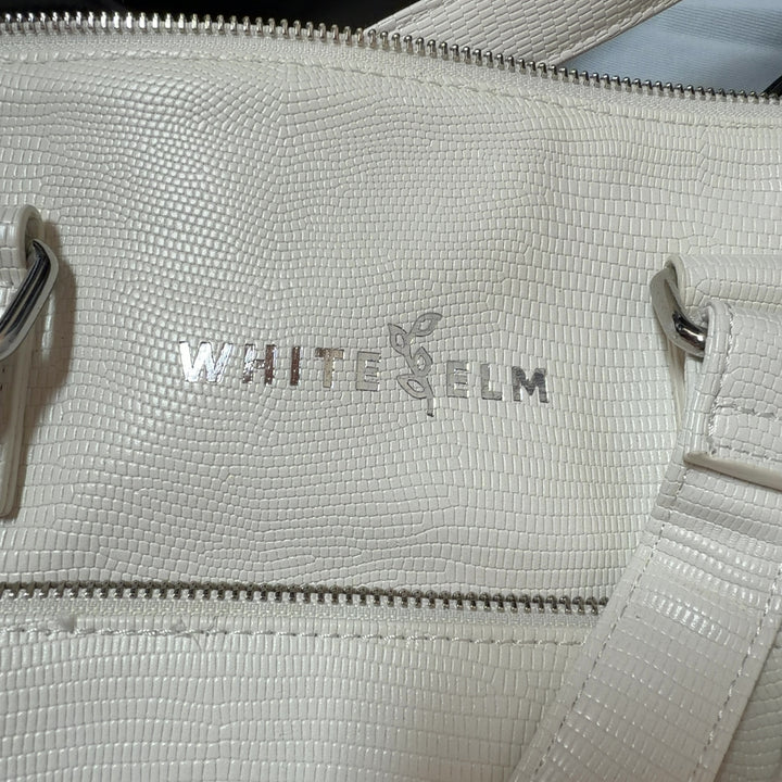 WHITE ELM cream leather tote bag worn on shoulder, back view showing structured silhouette