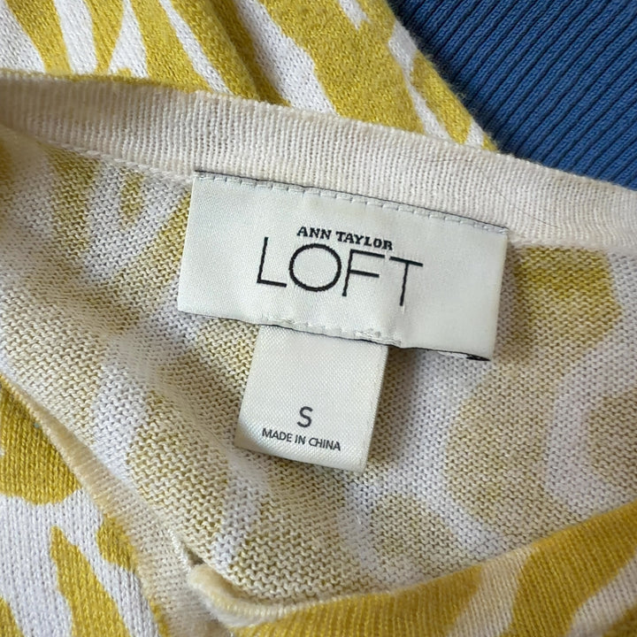 Tag view of yellow zebra print cardigan showing geometric stripe pattern and relaxed fit silhouette