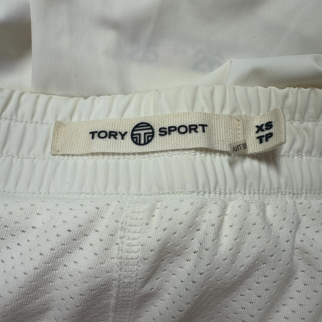 Cream pleated athletic skirt back view, TORY SPORT sports skirt with navy side stripe detail