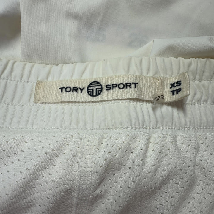 Cream pleated athletic skirt back view, TORY SPORT sports skirt with navy side stripe detail