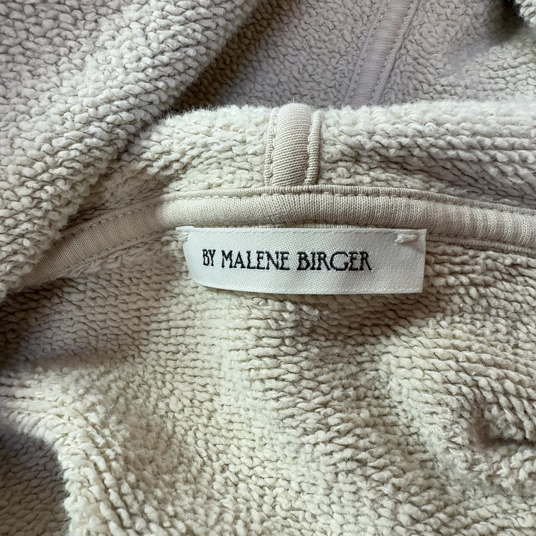 Tag view of cream organic cotton hoodie sweatshirt showing hood and relaxed silhouette