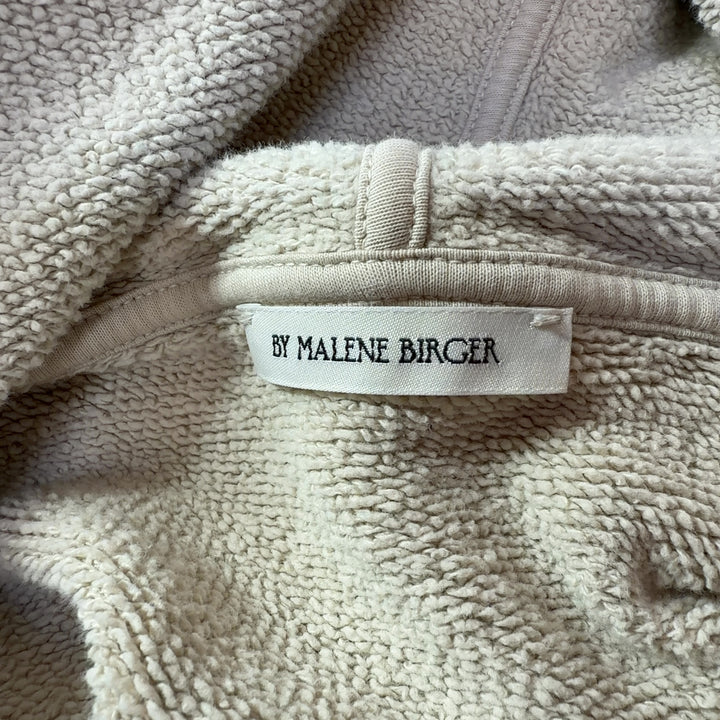 Tag view of cream organic cotton hoodie sweatshirt showing hood and relaxed silhouette