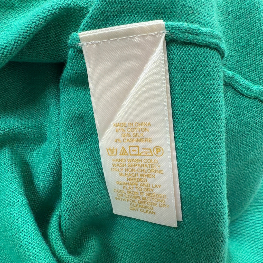 Tag view of Kate Spade green cardigan showing classic silhouette and button detailing