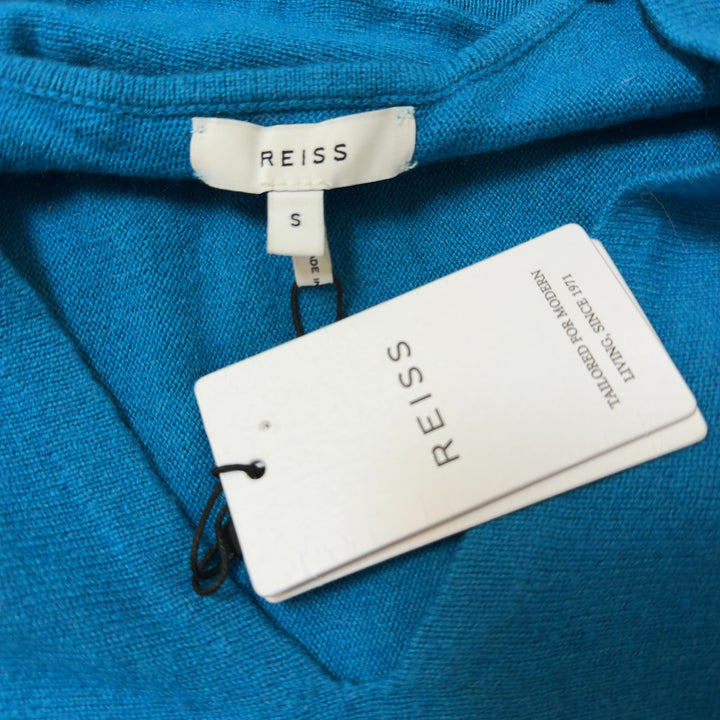 Blue V-neck cashmere blend knit sweater with ruched sleeves, back view on model
