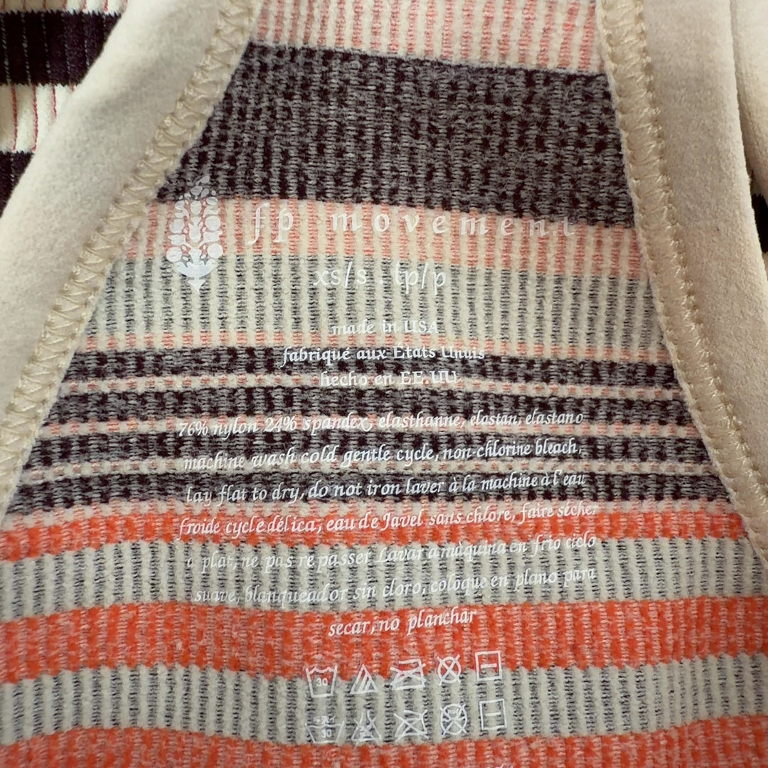 Tag view of orange striped athletic crop top sports bra showing supportive design and fit