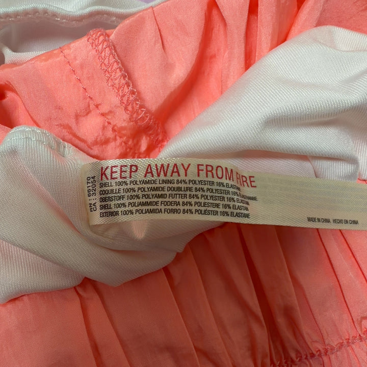Coral pink ruched athletic shorts back view, showing high-waisted fit and ruching detail