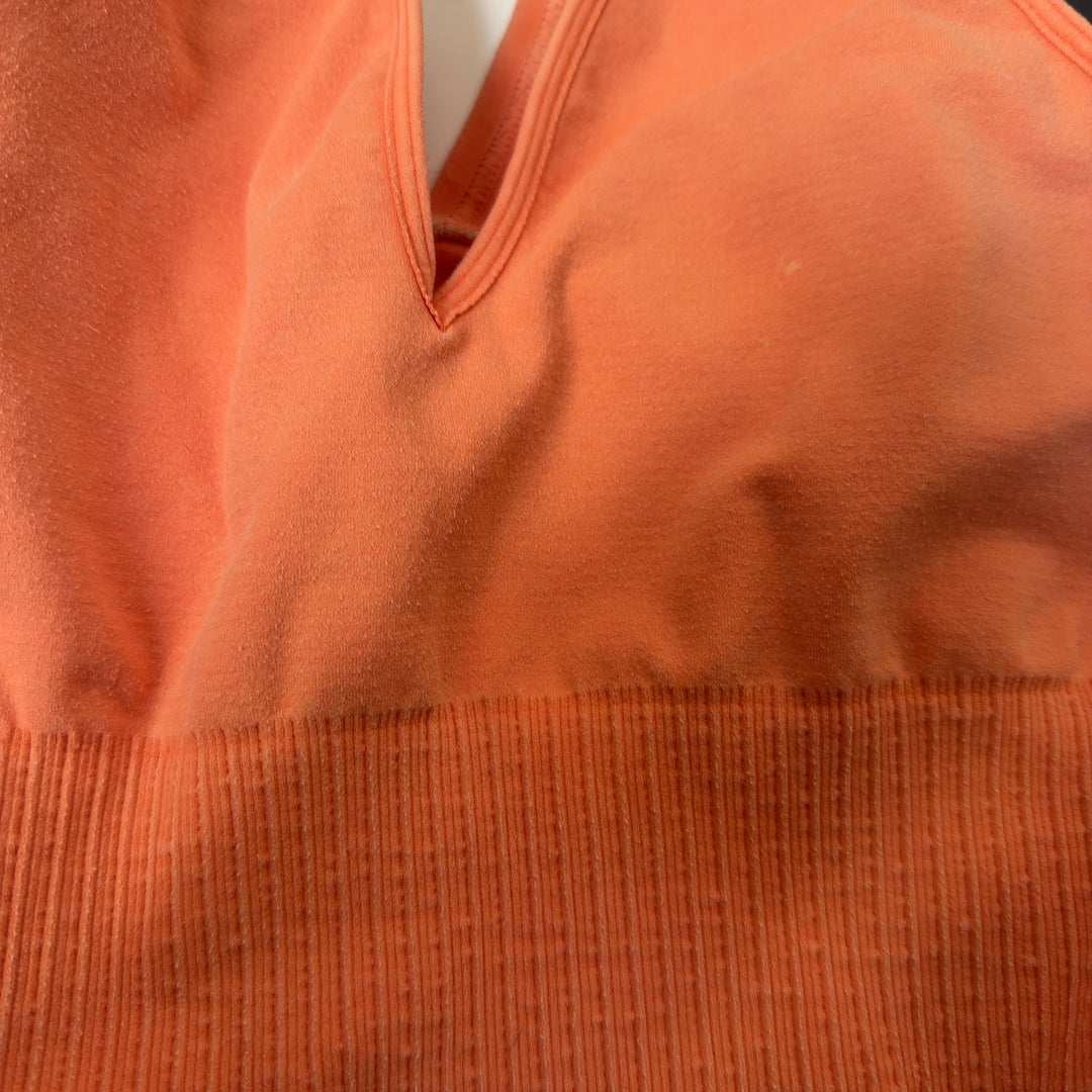 Peach ribbed crop tank top back view showing sleek design and fit