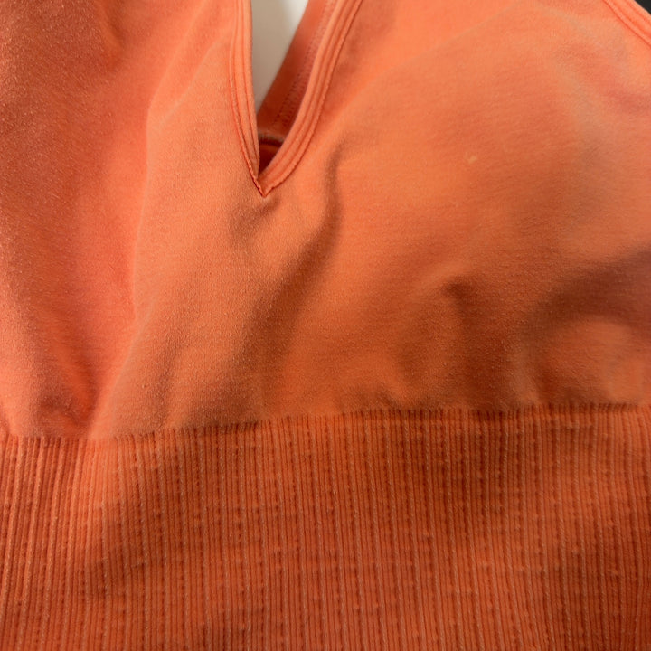Peach ribbed crop tank top back view showing sleek design and fit
