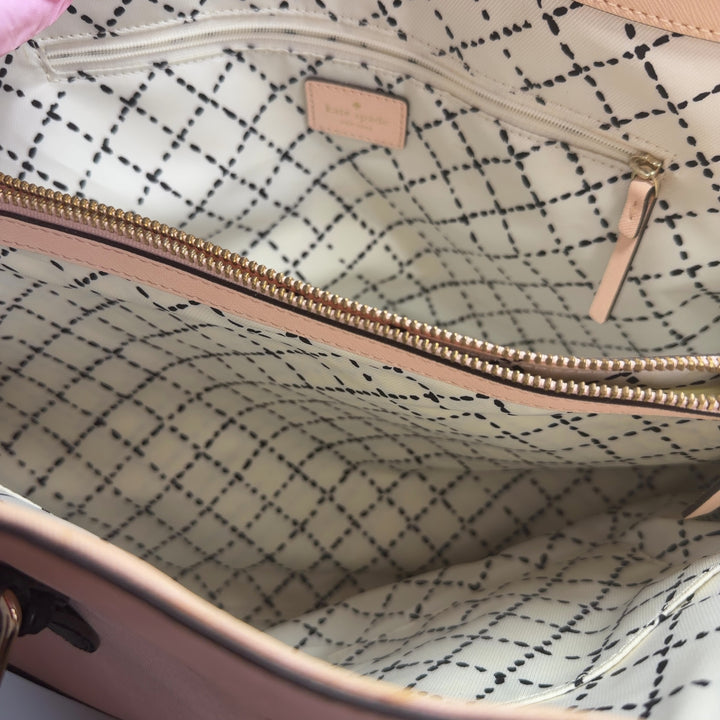 Kate Spade cream and black colorblock shoulder tote bag worn on shoulder, back view showing structured silhouette