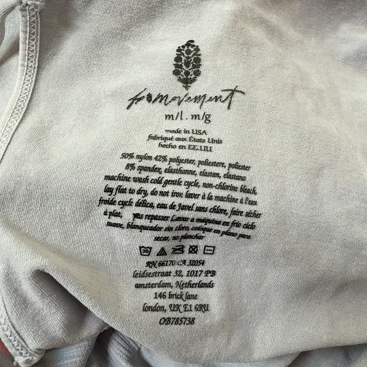Tag view of cream ribbed tank all-in-one jumpsuit showing fitted silhouette and high-waisted design