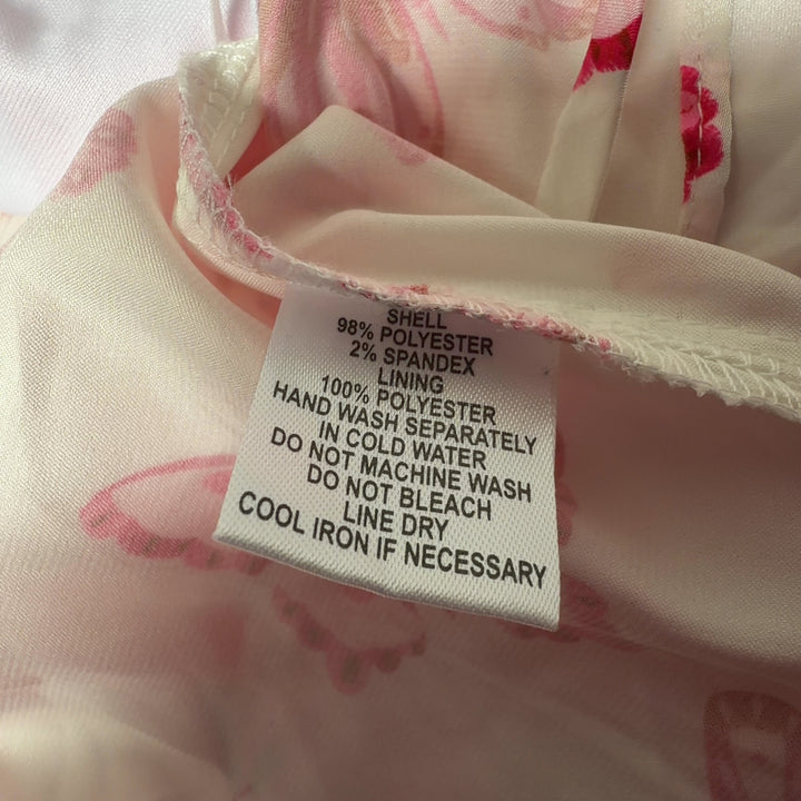 Pink butterfly print crop top with tie-back closure detail, back view