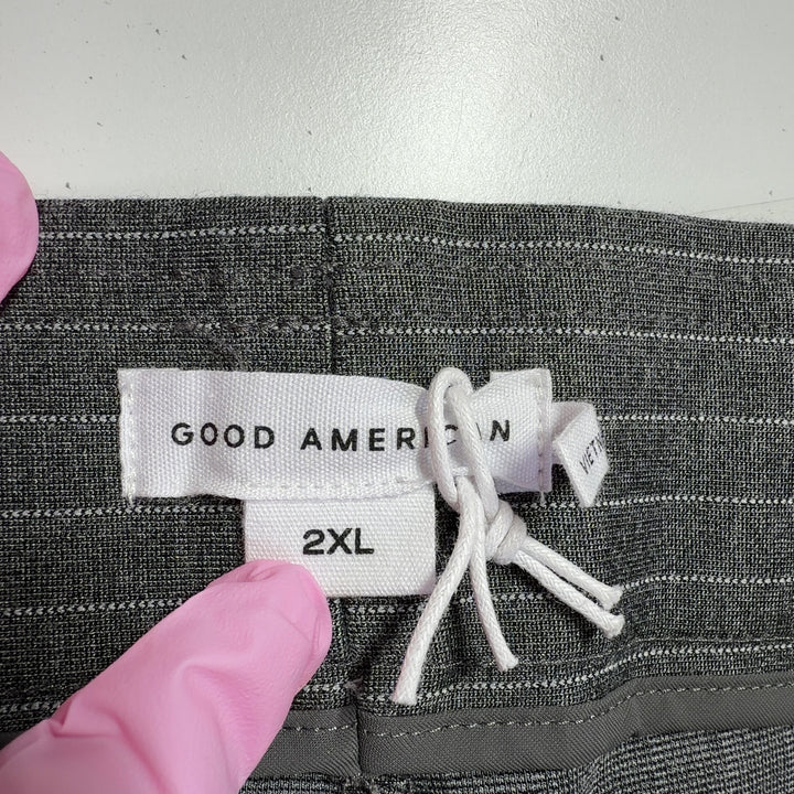 Tag view of gray pinstriped cropped flare pants showing flattering fit and cropped ankle length
