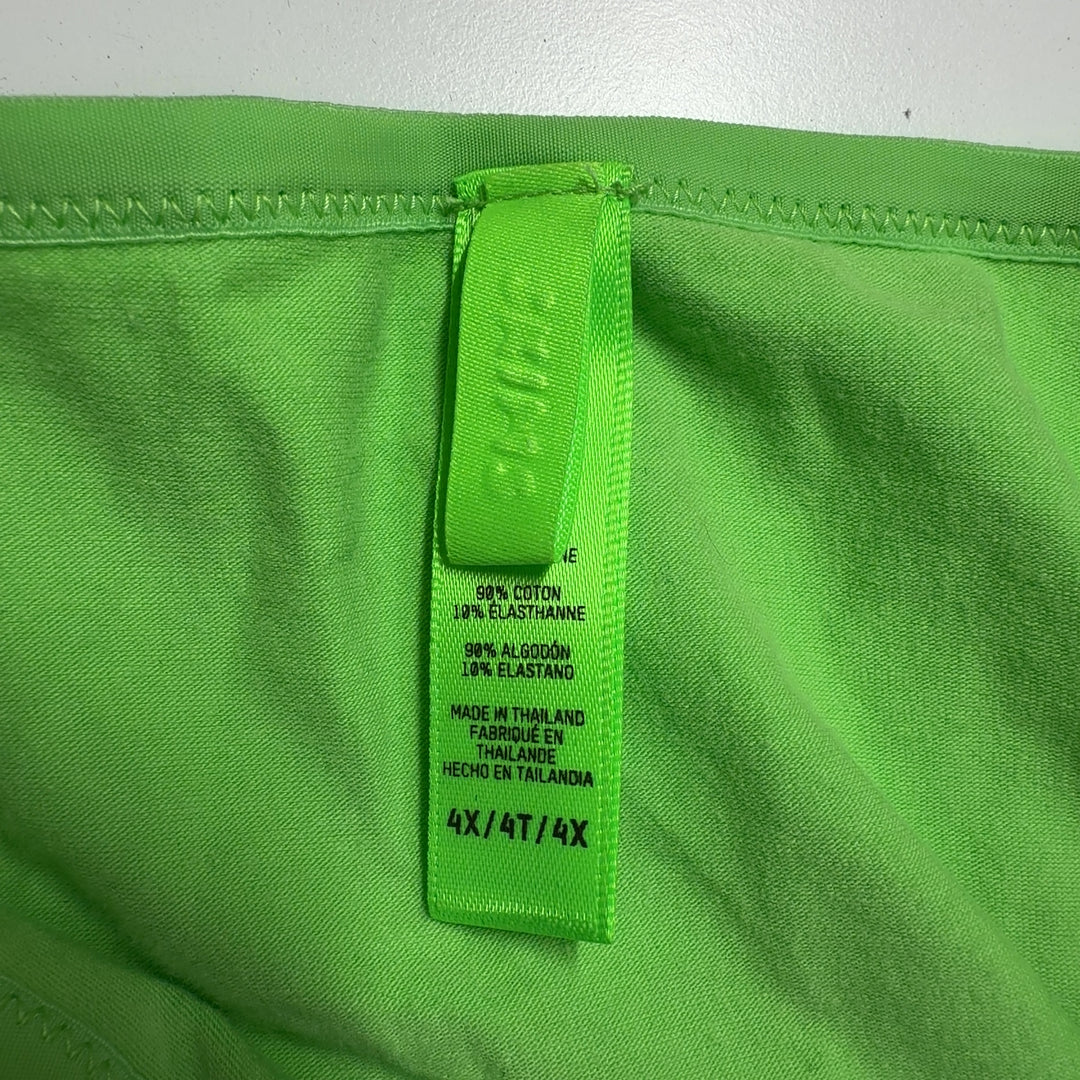 Tag view of woman wearing green cropped t-shirt by Skims with black fitted leggings